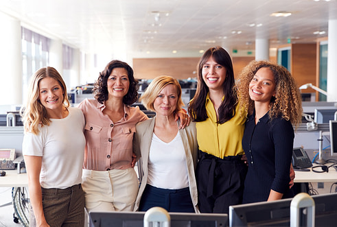Portrait Of Smiling Female Business Team Working In Modern Offic